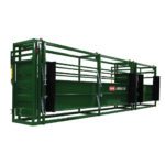 A green cattle crate with black rails and doors.